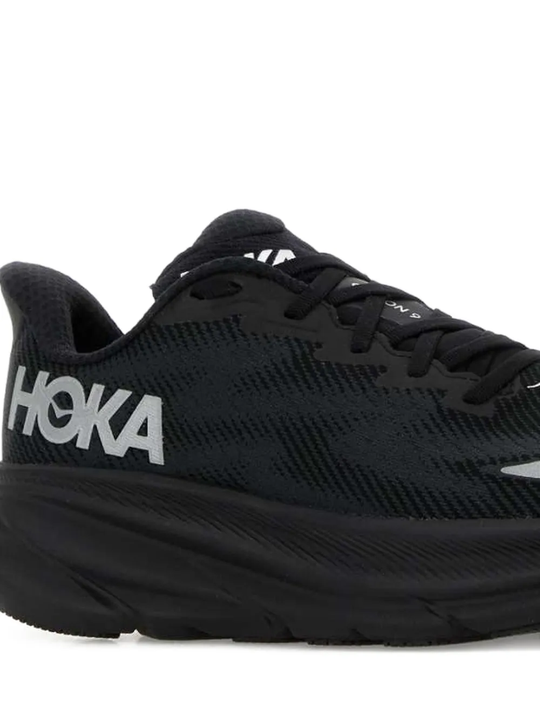 Close up of the black sneakers, showing texture of the mesh