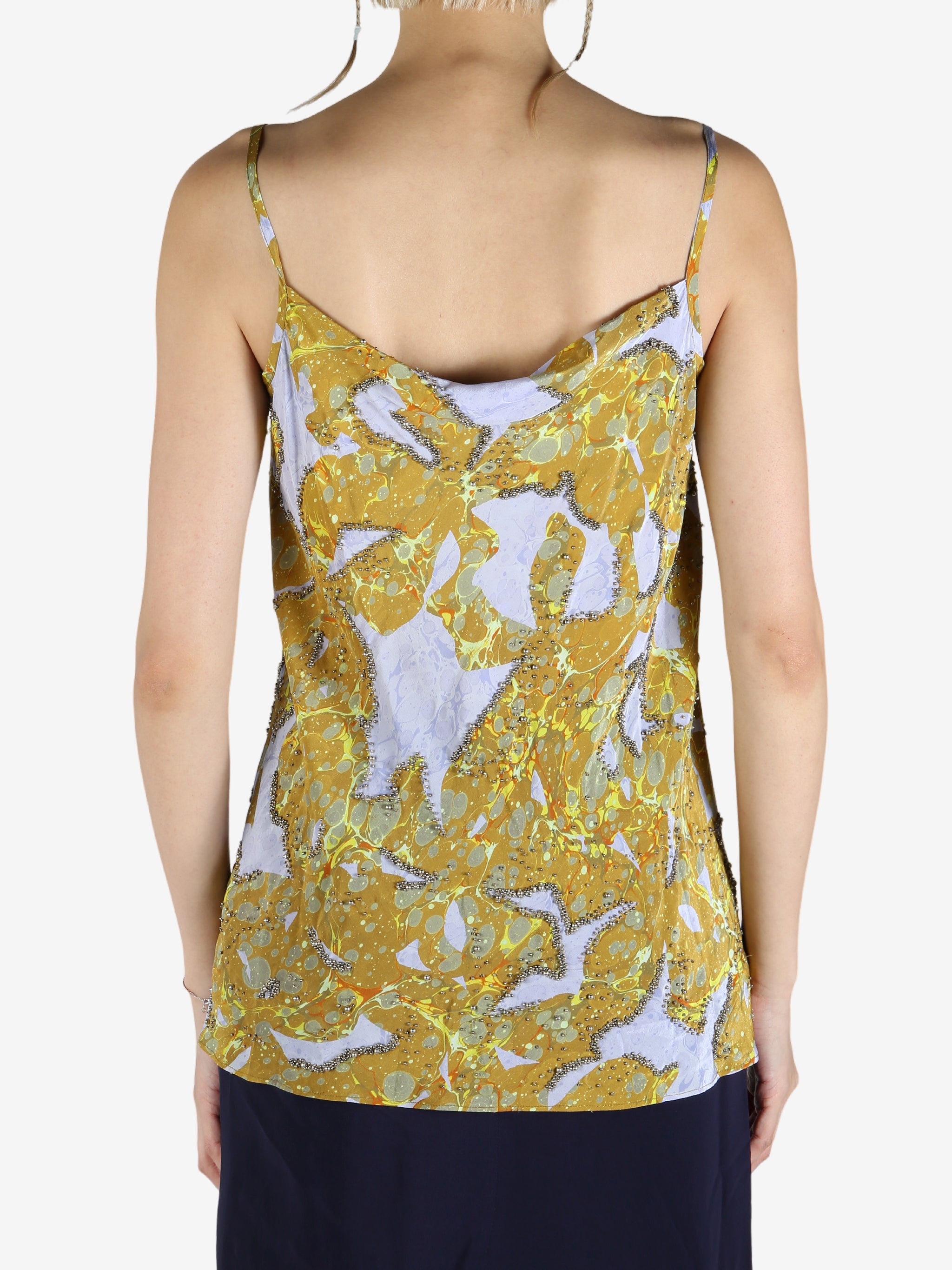 Yellow top worn by a person, showing the top's fit