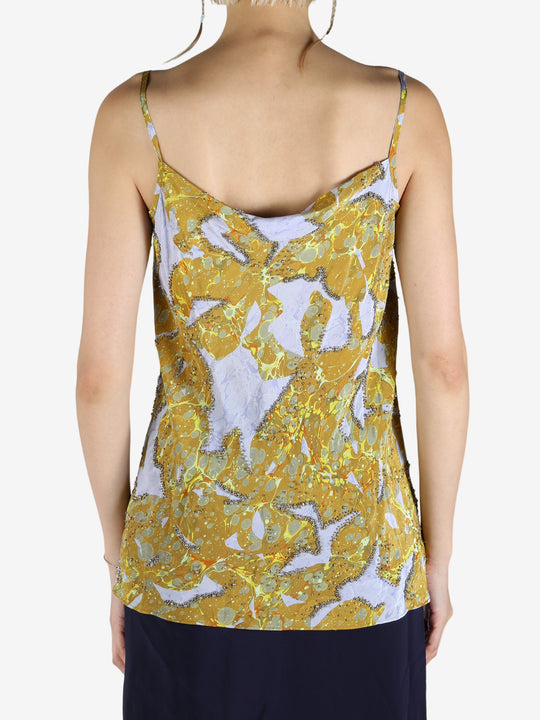 Yellow top worn by a person, showing the top's fit