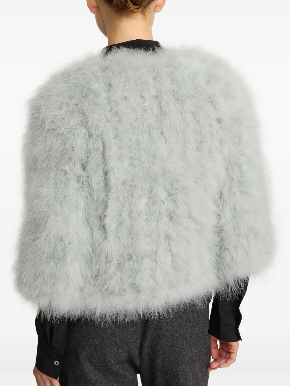 Grey coat worn by a person, showing the coat fit