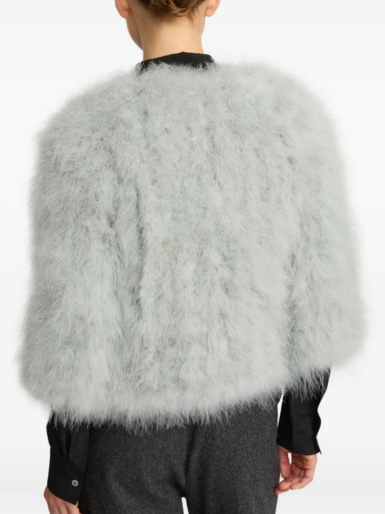 Grey coat worn by a person, showing the coat fit