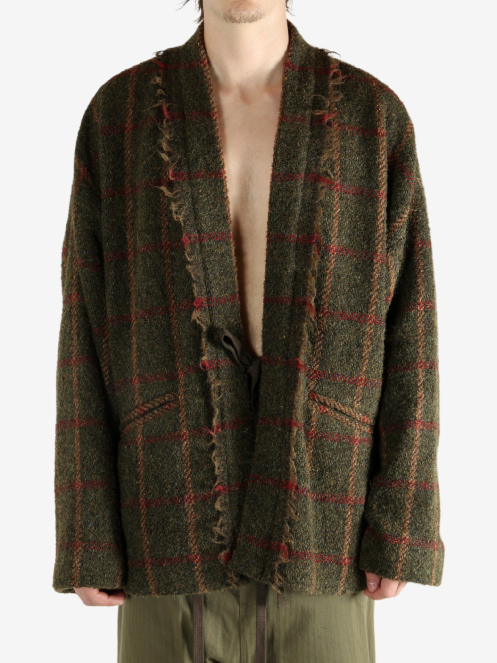 Green jacket worn by a person, showing the jacket's fit