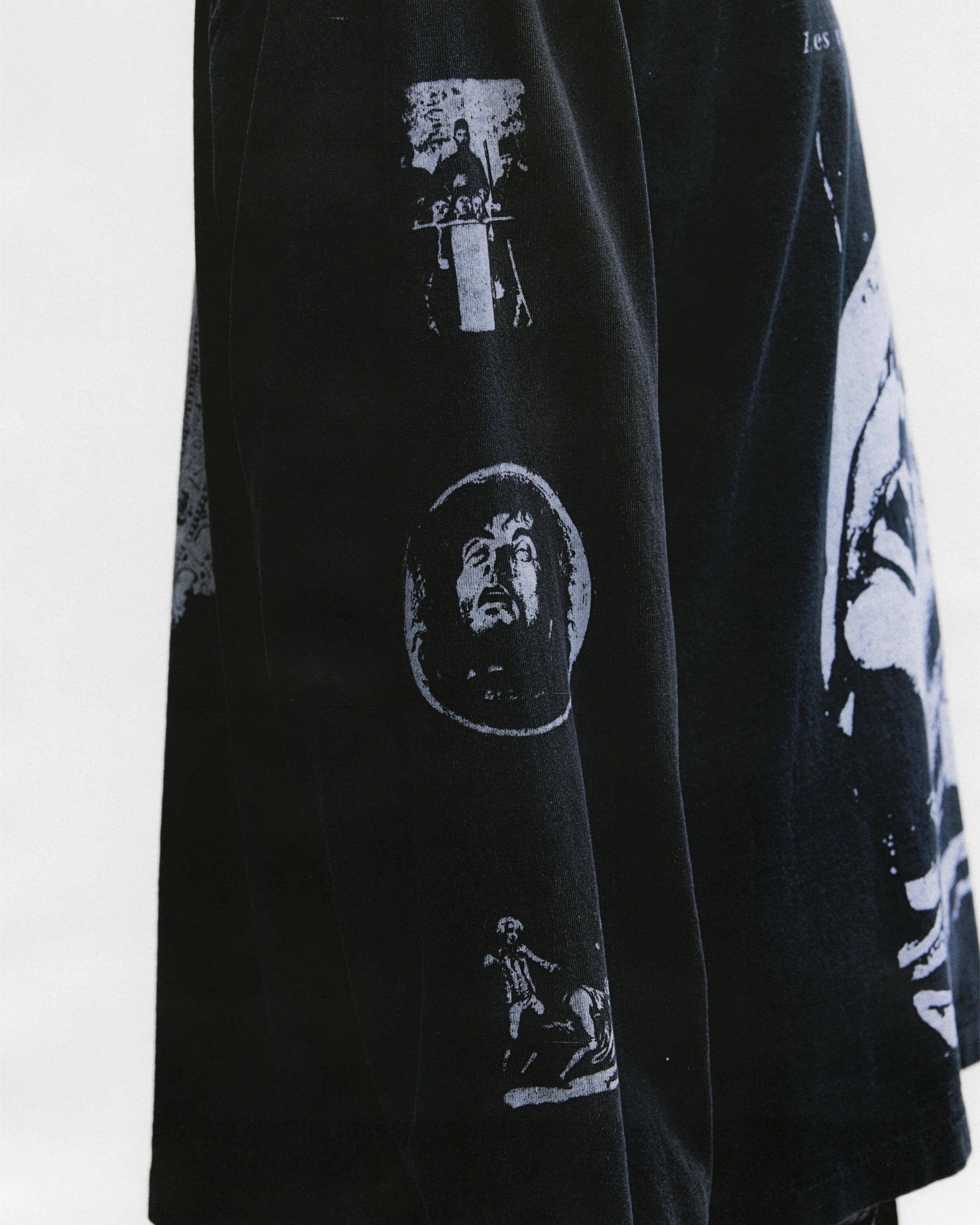 Black shirts worn by a person, showing the shirts fit