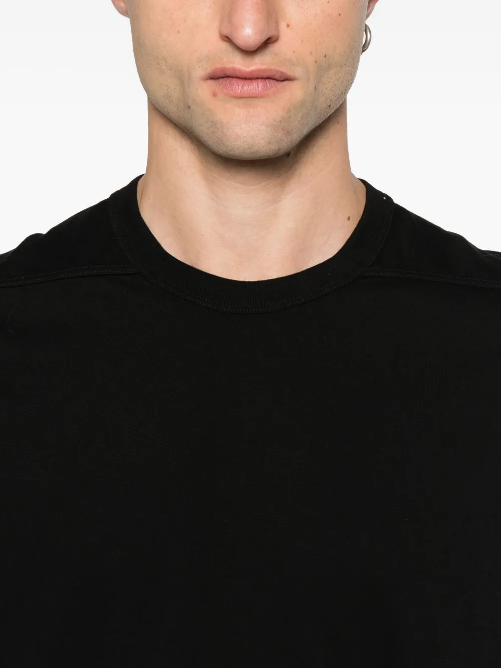 Close up of the black t-shirt, showing texture of the cotton fabric