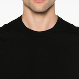 Close up of the black t-shirt, showing texture of the cotton fabric