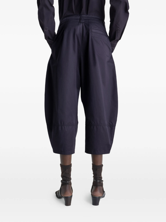 Navy pants worn by a person, showing the pants's fit