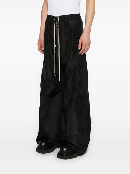 Black pants worn by a person, showing the pants fit