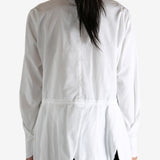 White shirt worn by a person, showing the shirt's fit