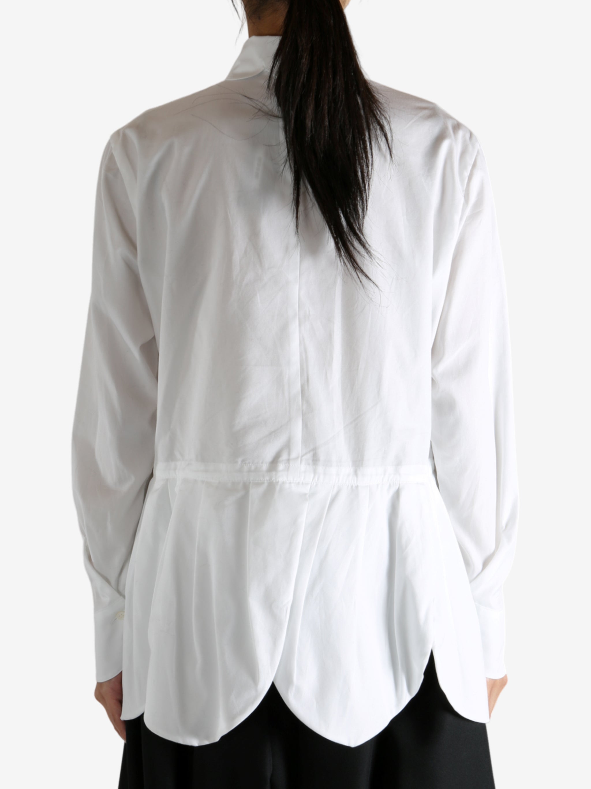 White shirt worn by a person, showing the shirt's fit