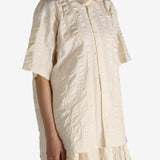 White shirt worn by a person, showing the shirt's fit