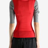 Red knitwear worn by a person, showing the knitwear's fit