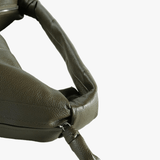 Close up of green bag, showing texture of the leather fabric