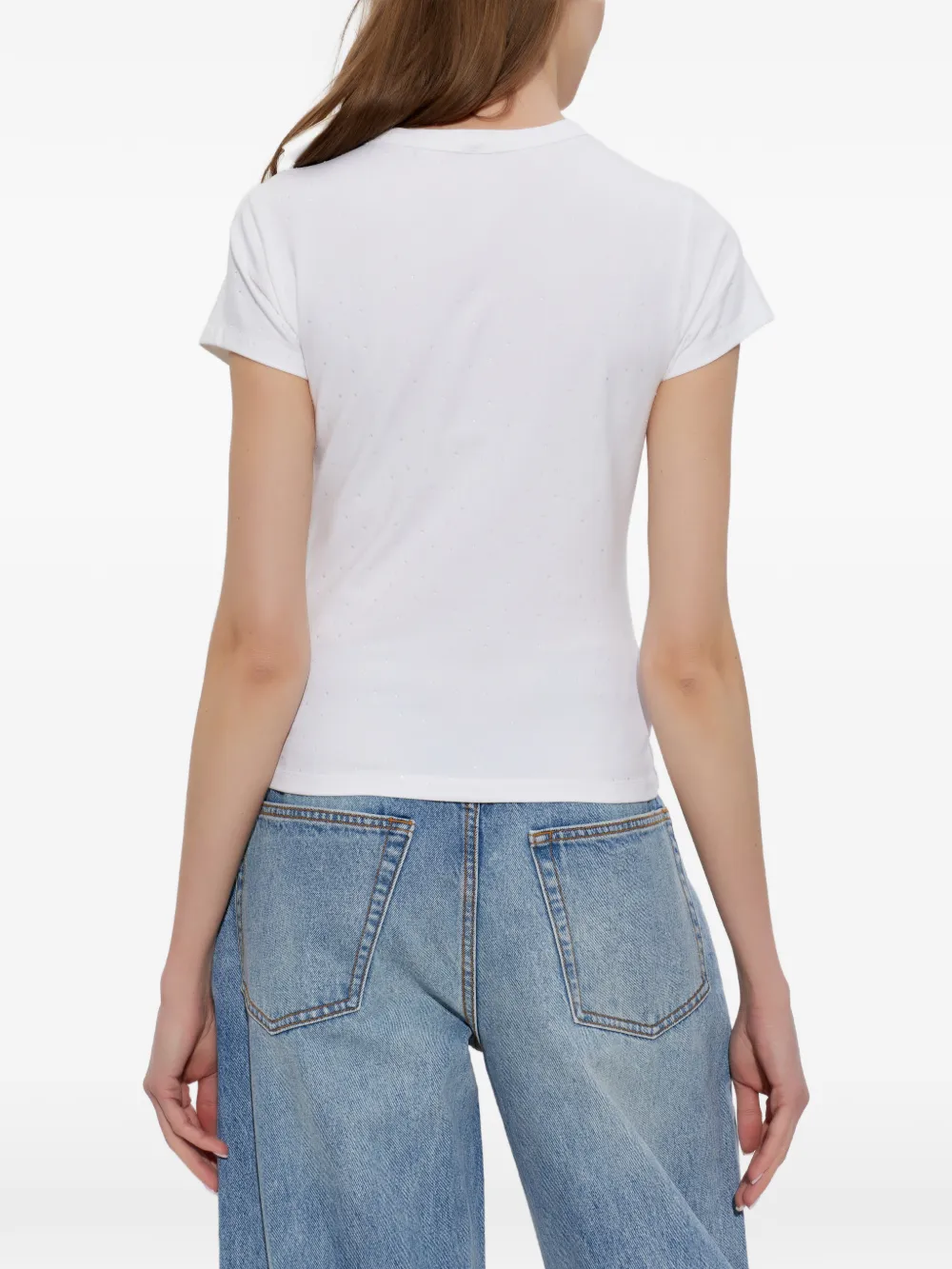 white T-shirt worn by a person, showing the shirt's fit