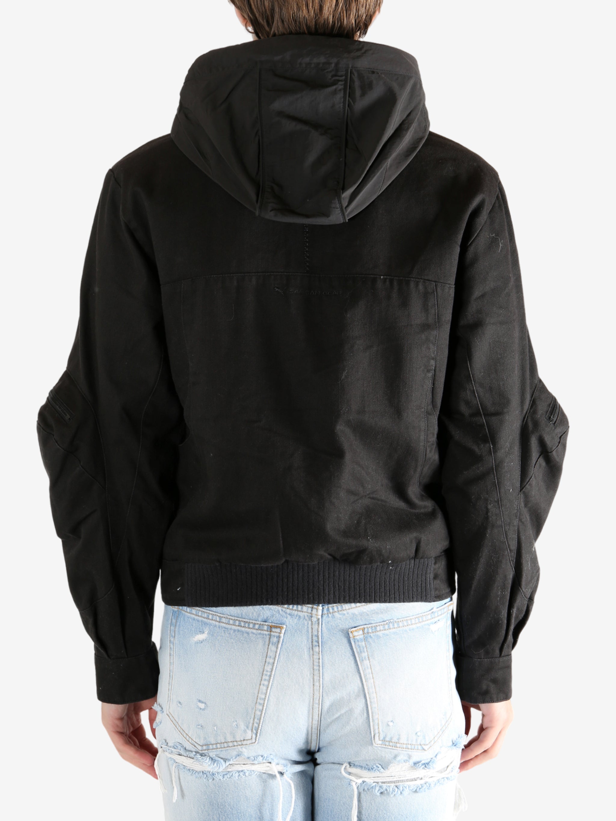 Black jacket worn by a person, showing the jacket's fit