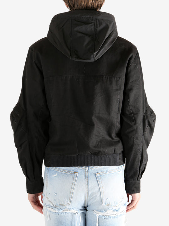 Black jacket worn by a person, showing the jacket's fit