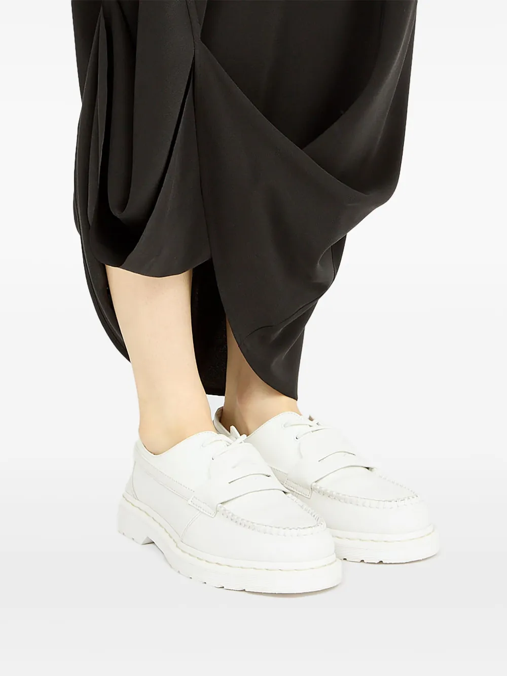 White boots worn by a person, showing the boots fit