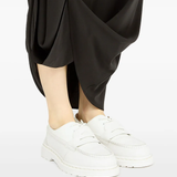 White boots worn by a person, showing the boots fit