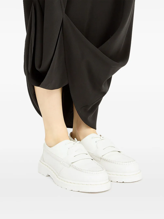 White boots worn by a person, showing the boots fit