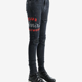 Black jeans worn by a person, showing the jeans fit