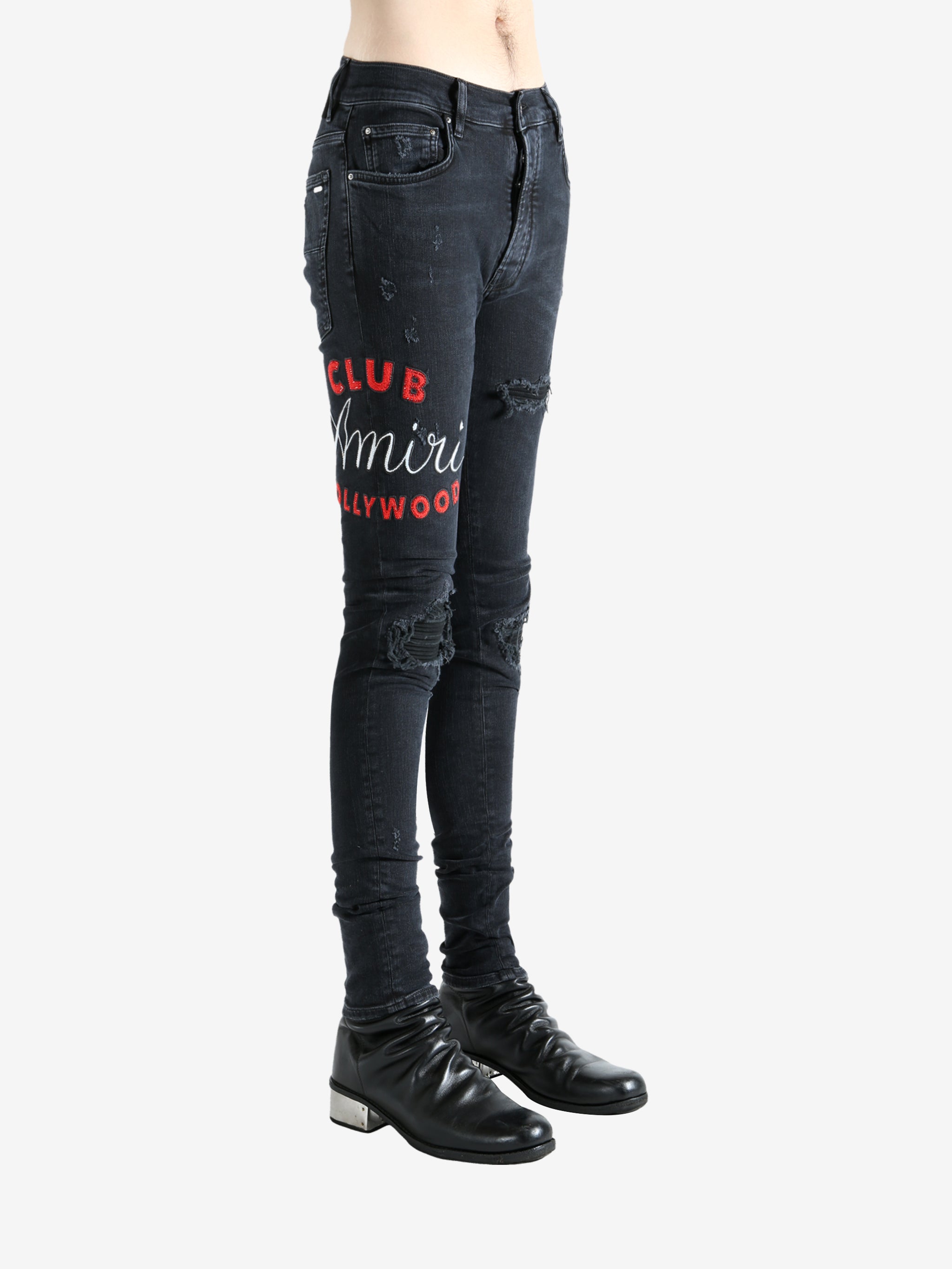 Black jeans worn by a person, showing the jeans fit