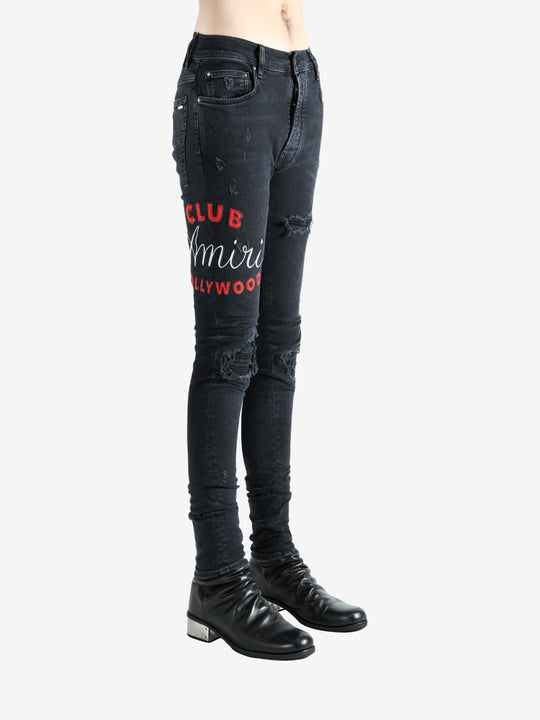Black jeans worn by a person, showing the jeans fit