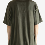 Green t-shirt worn by a person, showing the t-shirt's fit