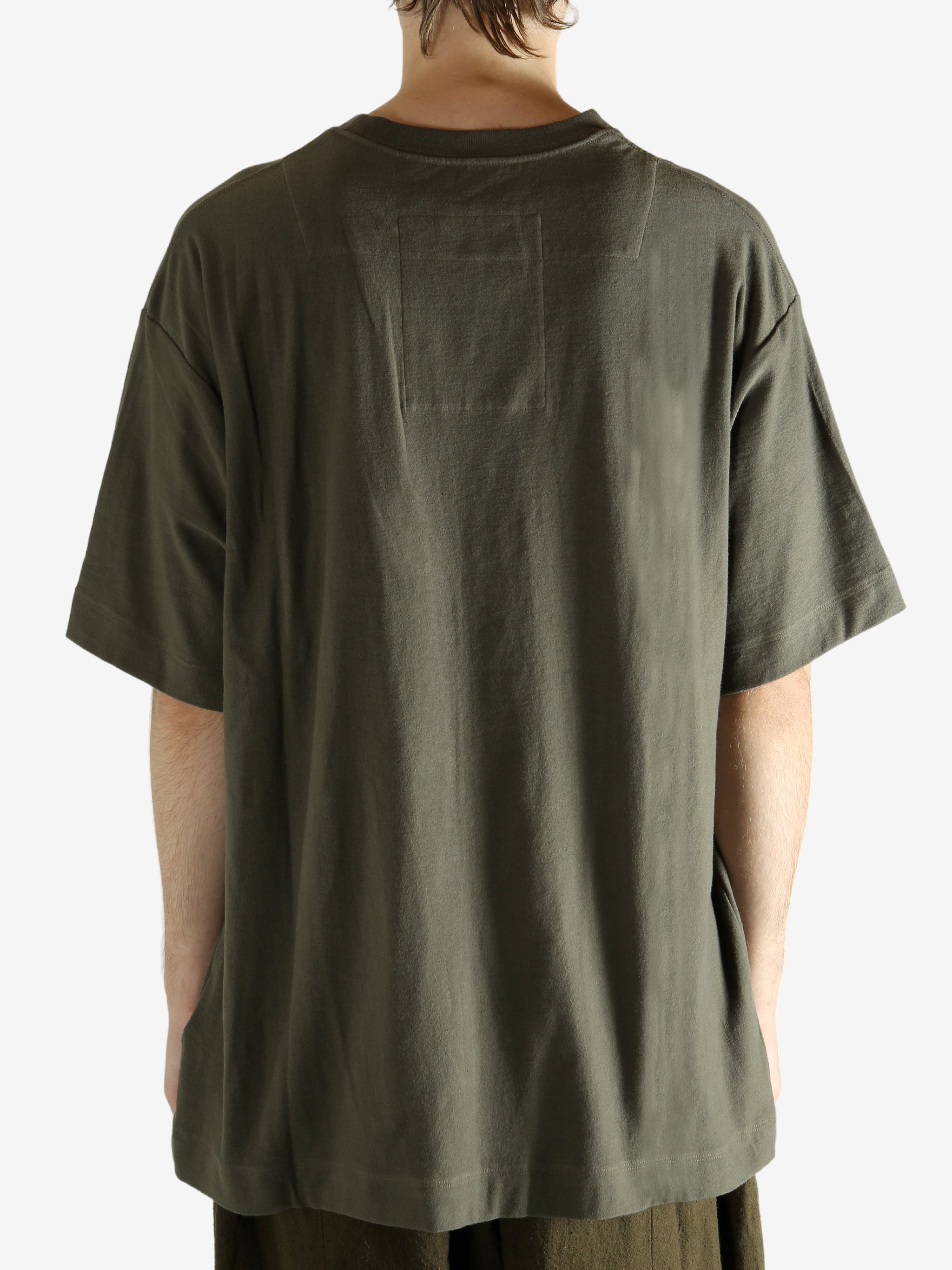 Green t-shirt worn by a person, showing the t-shirt's fit
