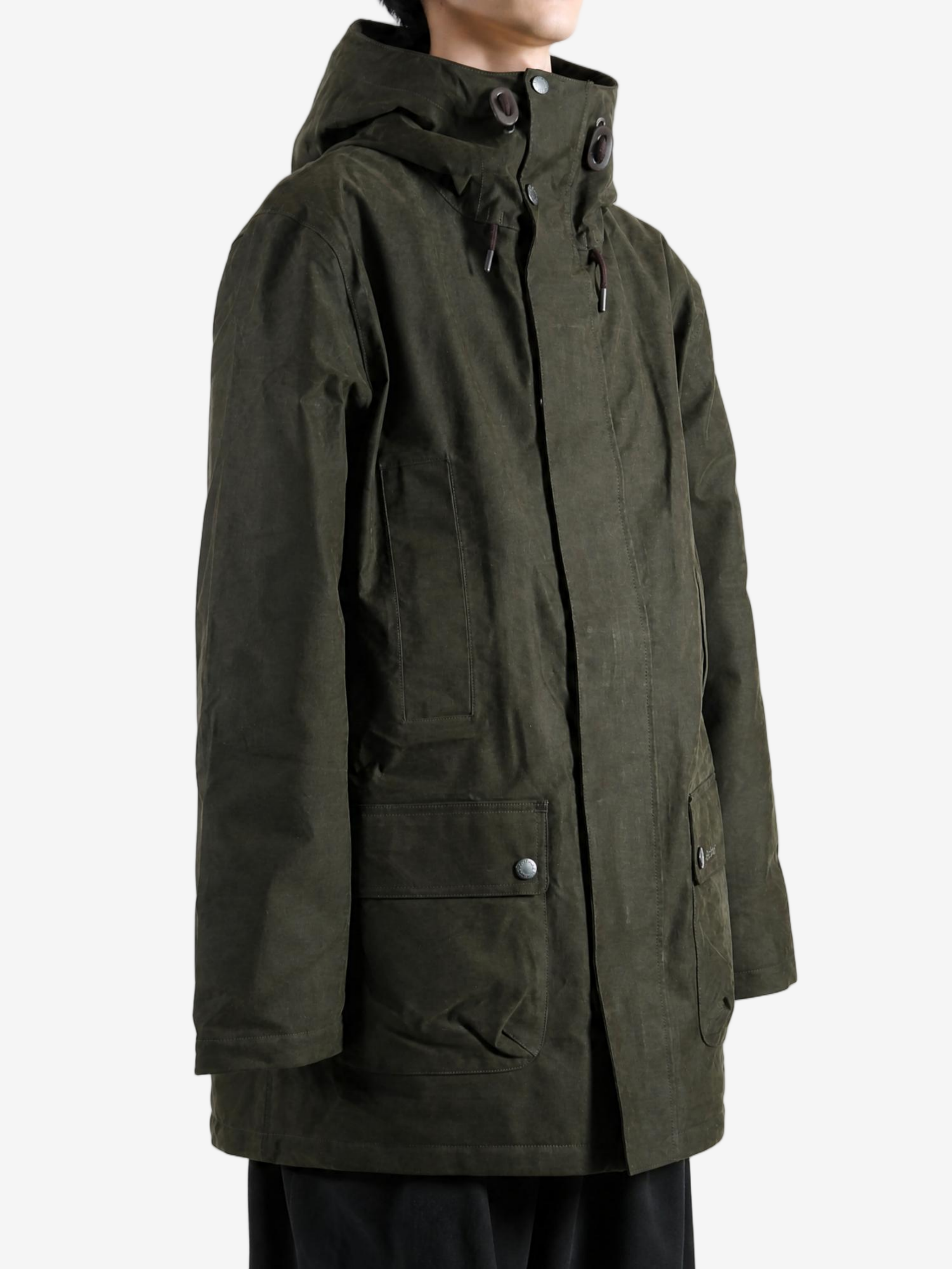 Green jacket worn by a person, showing the jacket fit