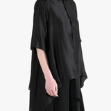 Black shirt worn by a person, showing the shirt's fit