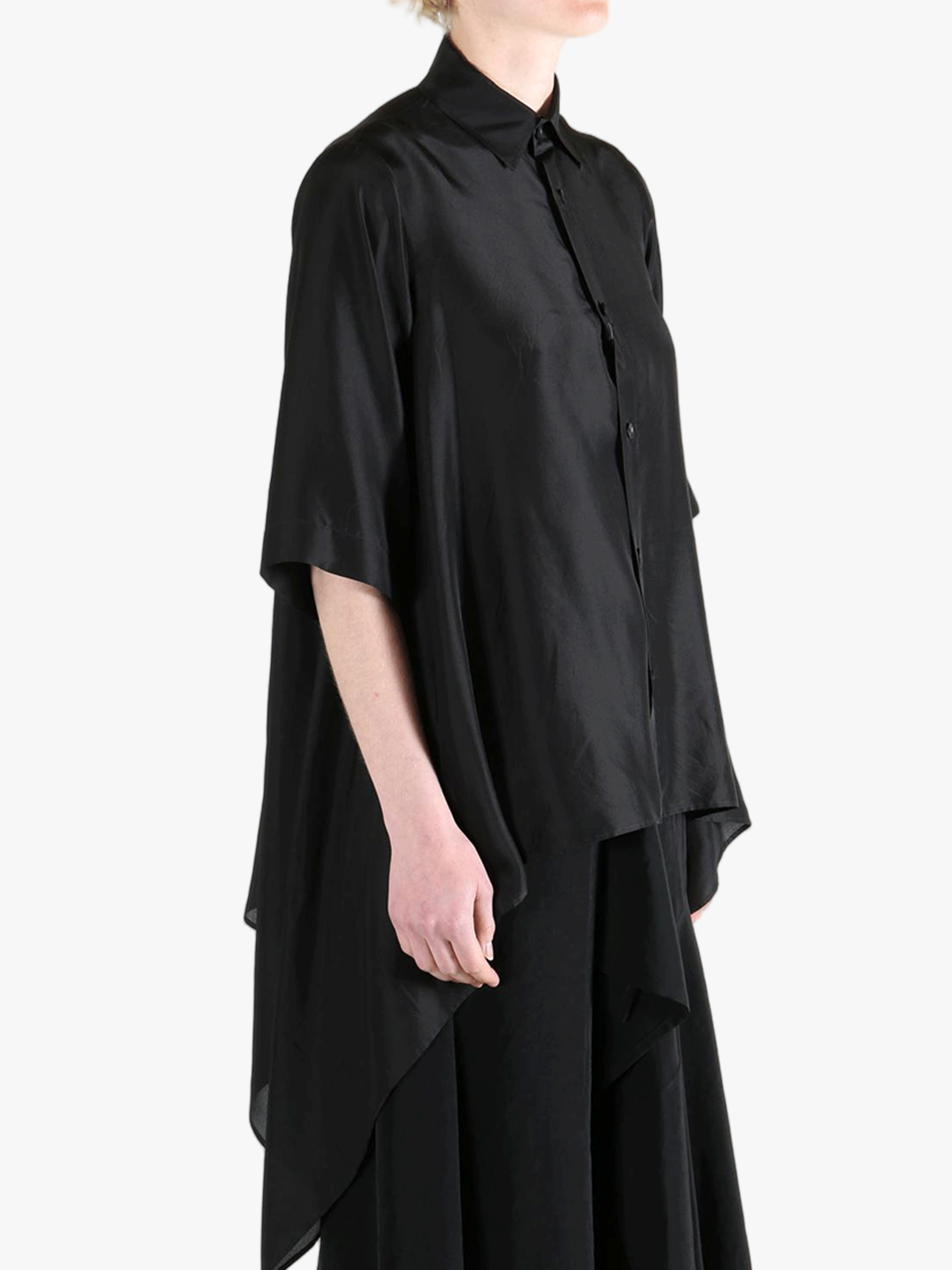 Black shirt worn by a person, showing the shirt's fit