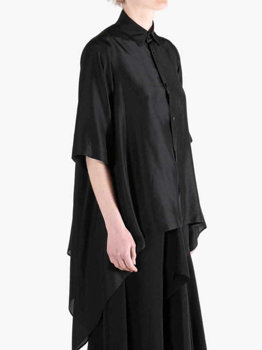 Black shirt worn by a person, showing the shirt's fit