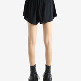 Black shorts worn by a person, showing the shorts' fit