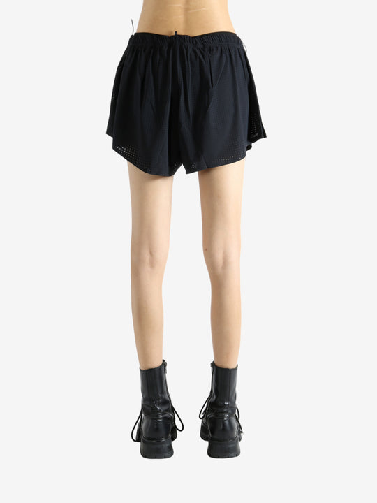 Black shorts worn by a person, showing the shorts' fit