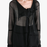 Black shirt worn by a person, showing the shirt fit