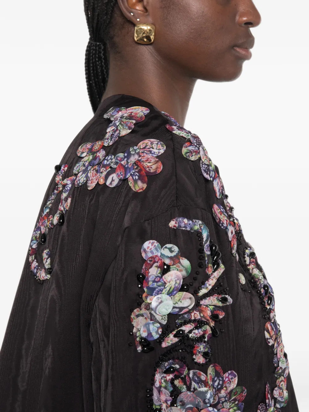 Black jacket worn by a person, showing the jacket fit