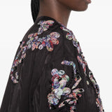 Black jacket worn by a person, showing the jacket fit