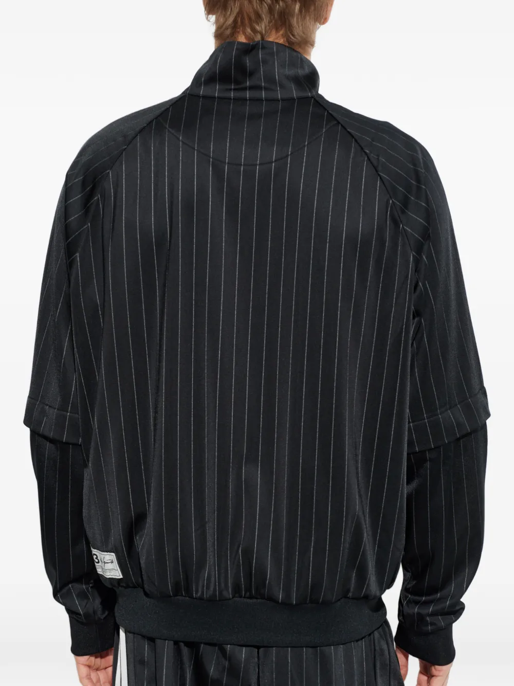 black jackets-coats worn by a person, showing the  jackets-coats fit