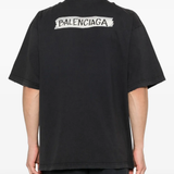 black t-shirt worn by a person, showing the t-shirt fit