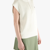 White vest worn by a person, showing the loose fit.