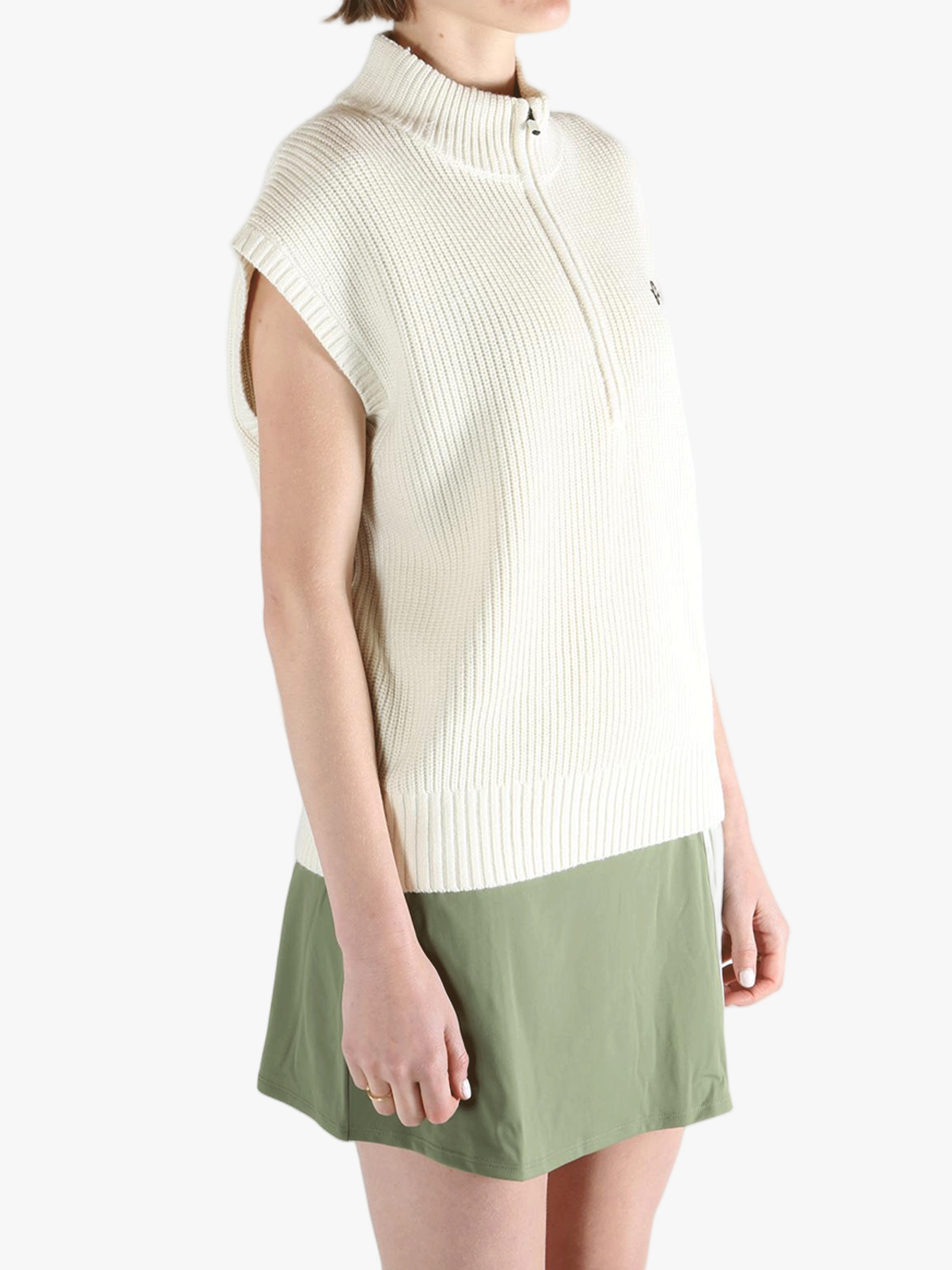 White vest worn by a person, showing the loose fit.