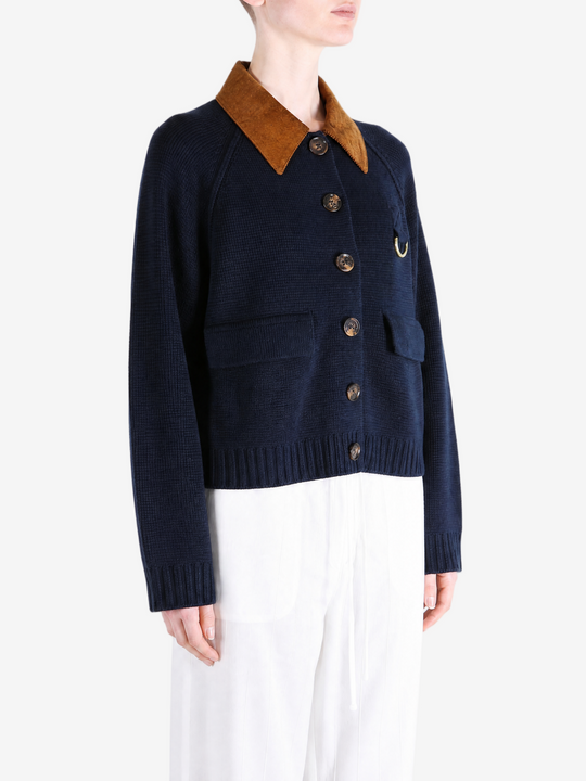 Navy knitwear worn by a person, showing the knitwear fit