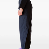 Black pants worn by a person, showing the pants's fit