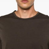 Brown t-shirt worn by a person, showing the t-shirt fit