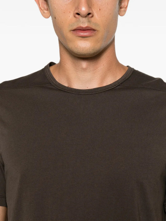 Brown t-shirt worn by a person, showing the t-shirt fit