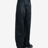 Black pants worn by a person, showing the pants fit