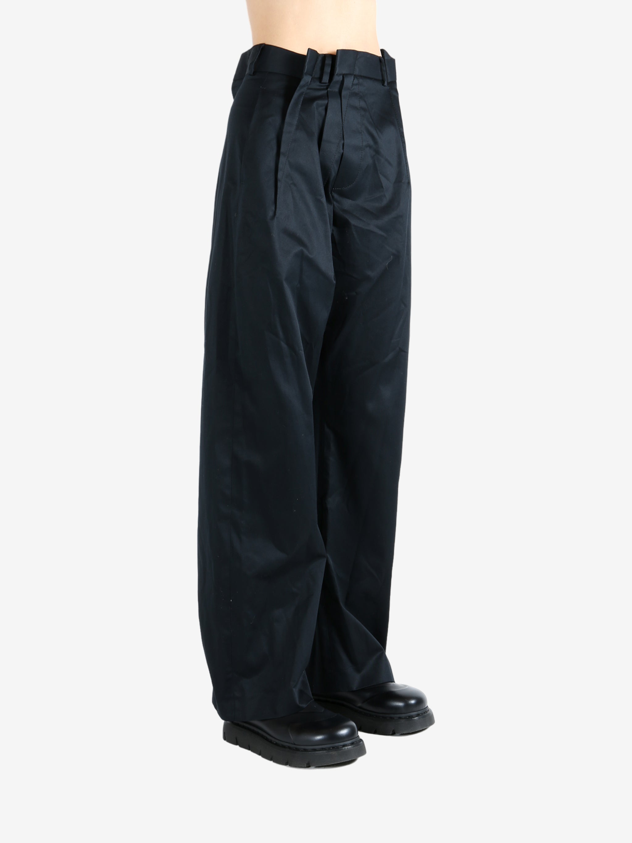 Black pants worn by a person, showing the pants fit