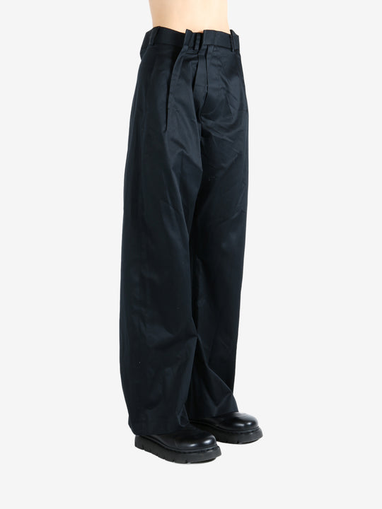 Black pants worn by a person, showing the pants fit