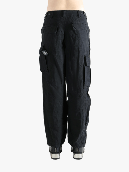 Black pants worn by a person, showing the pants fit