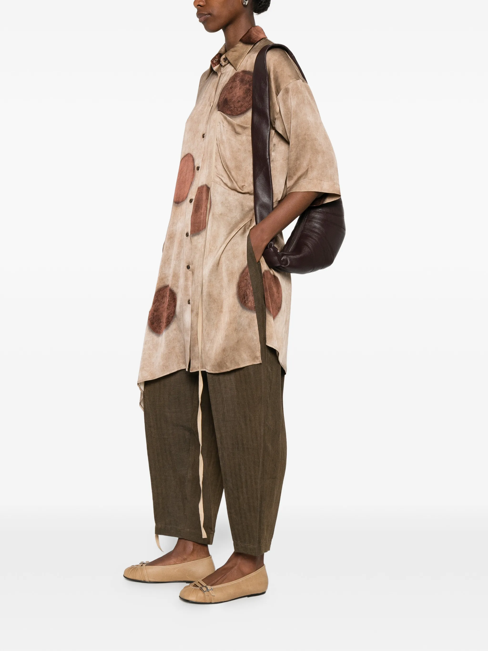 Brown top worn by a person, showing the top's fit