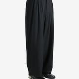 black pants  worn by a person, showing the pants fit